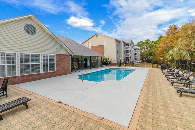 view of swimming pool featuring a patio area