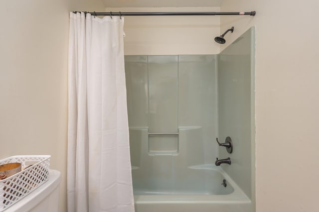 bathroom with shower / tub combo with curtain and toilet