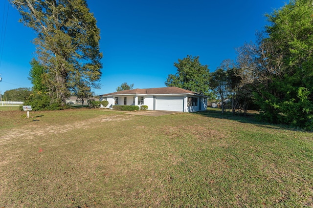 exterior space featuring a garage and a front lawn