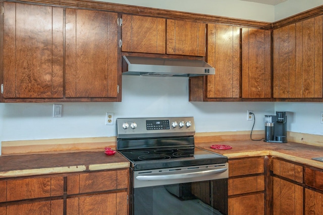 kitchen with stainless steel electric stove and range hood