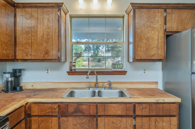 kitchen with stainless steel fridge and sink