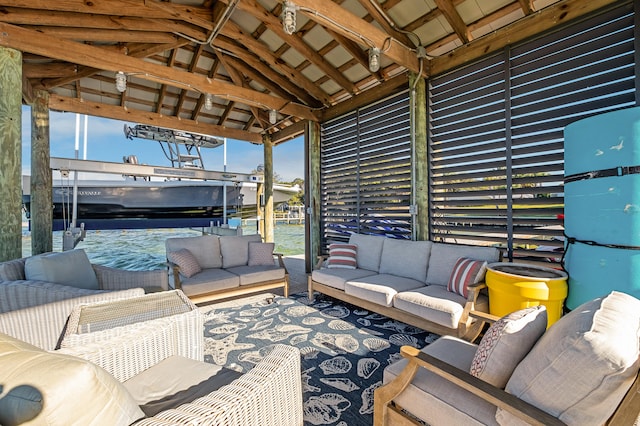 view of patio / terrace with a gazebo, an outdoor living space, and a water view