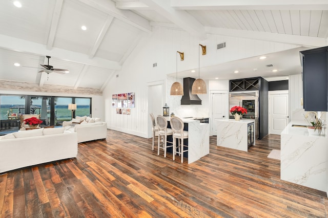 living room featuring high vaulted ceiling, sink, dark hardwood / wood-style floors, ceiling fan, and beam ceiling