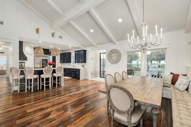 dining room featuring dark wood-type flooring, high vaulted ceiling, sink, beamed ceiling, and a notable chandelier