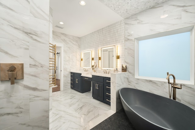 bathroom with a bathing tub, vanity, and tile walls