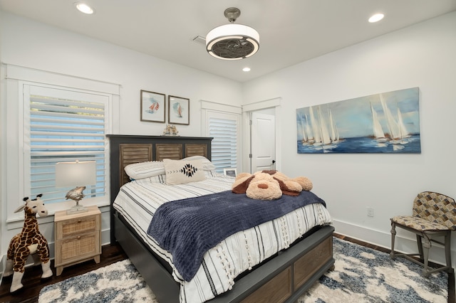 bedroom with ceiling fan and dark wood-type flooring