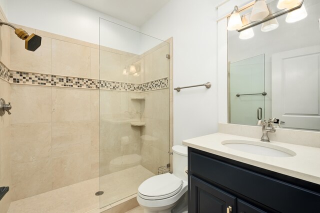 bathroom with vanity, toilet, and an enclosed shower