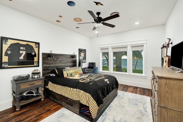 bedroom with ceiling fan and dark hardwood / wood-style flooring