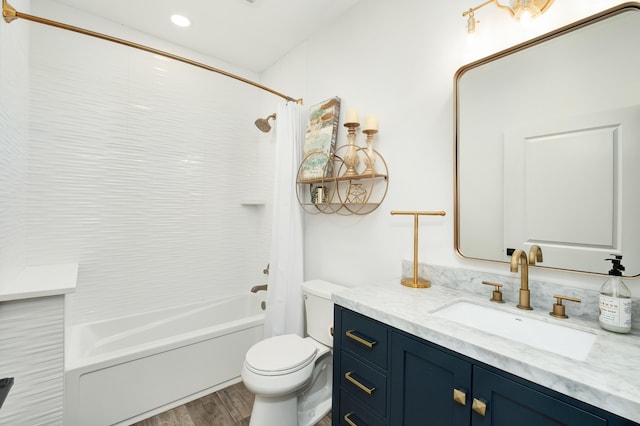 full bathroom featuring shower / bath combo with shower curtain, vanity, wood-type flooring, and toilet