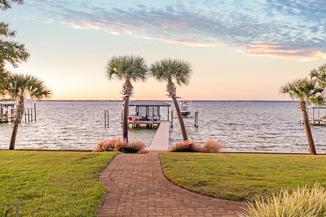 dock area featuring a water view and a lawn