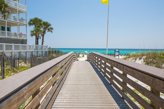 surrounding community with a beach view and a water view