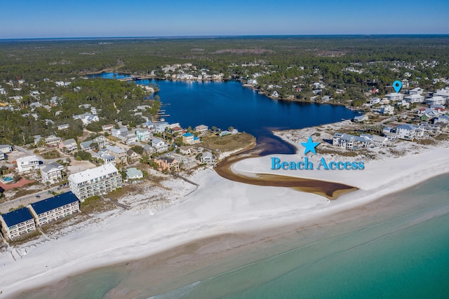 birds eye view of property featuring a water view and a beach view