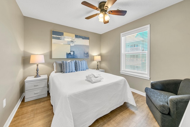 bedroom featuring ceiling fan and light hardwood / wood-style floors