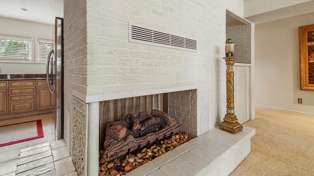 details with carpet flooring, a multi sided fireplace, and stainless steel refrigerator