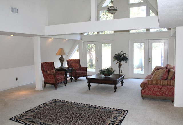 living room featuring french doors, carpet floors, and a high ceiling