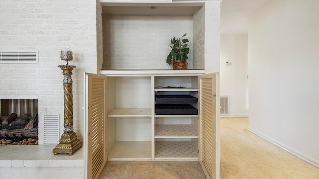 room details with carpet floors and a brick fireplace