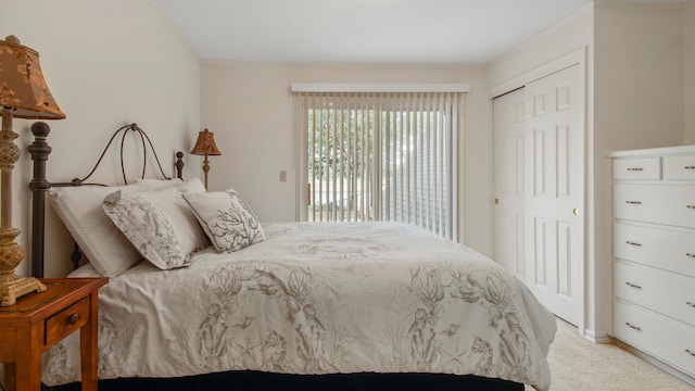 bedroom with light carpet and a closet