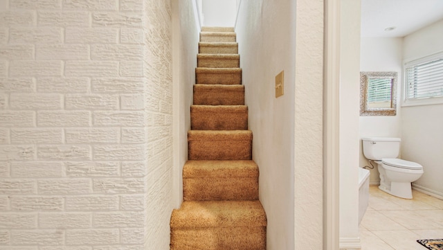 stairway with tile patterned floors