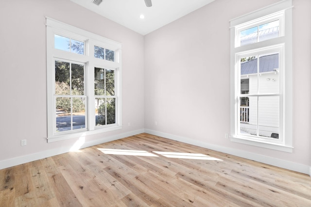 empty room with ceiling fan and light wood-type flooring