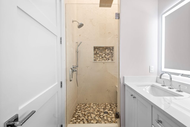 bathroom with vanity and a shower with shower door