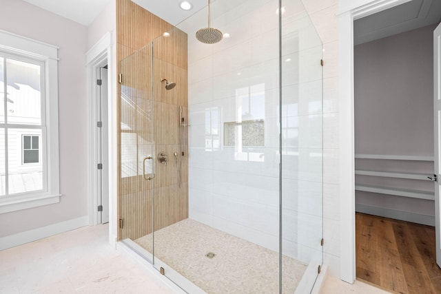 bathroom with hardwood / wood-style flooring and an enclosed shower