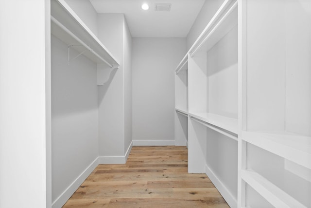 spacious closet with hardwood / wood-style flooring