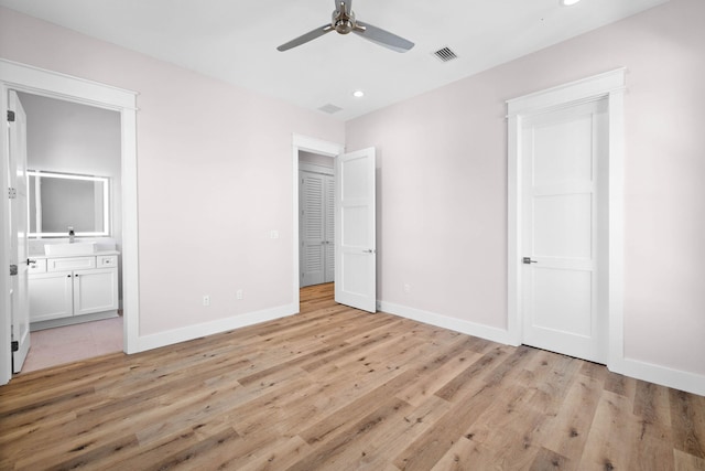 unfurnished bedroom with ensuite bath, ceiling fan, sink, and light wood-type flooring