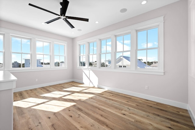 spare room featuring ceiling fan and light hardwood / wood-style floors