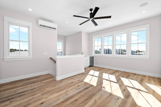 unfurnished living room with wine cooler, light hardwood / wood-style floors, an AC wall unit, and ceiling fan