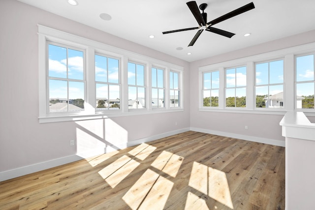 unfurnished sunroom with ceiling fan and plenty of natural light