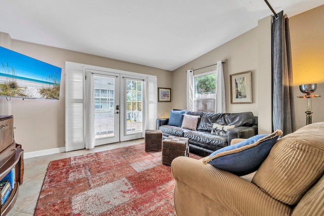 living room with vaulted ceiling, light tile patterned floors, and french doors