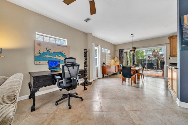 office area featuring light tile patterned floors, ceiling fan, and a healthy amount of sunlight