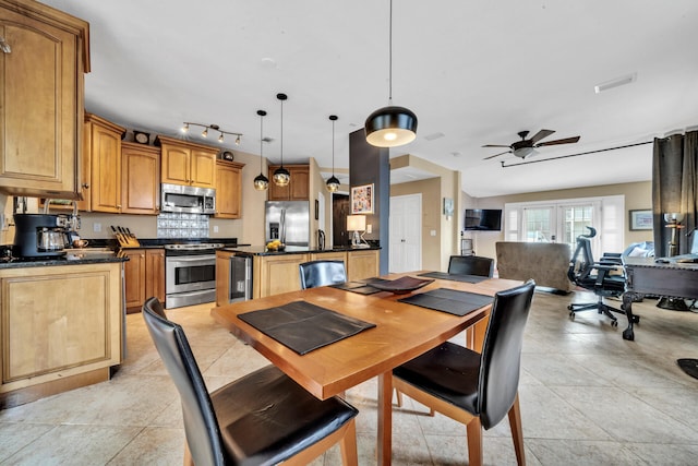 dining area with french doors, ceiling fan, sink, light tile patterned floors, and wine cooler