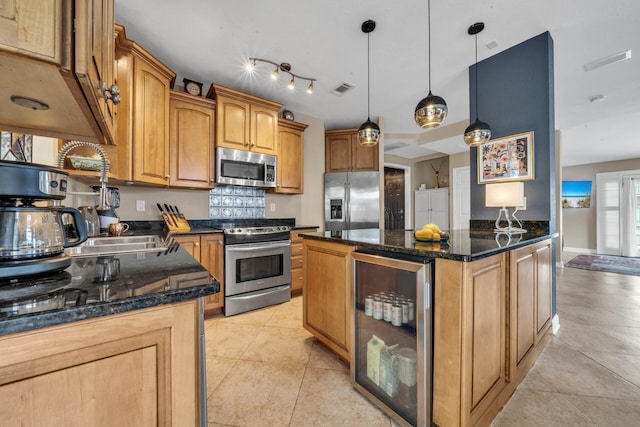 kitchen with stainless steel appliances, pendant lighting, light tile patterned floors, dark stone countertops, and wine cooler