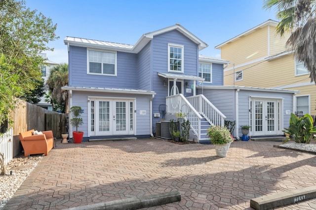 rear view of property with french doors, a patio area, and central air condition unit