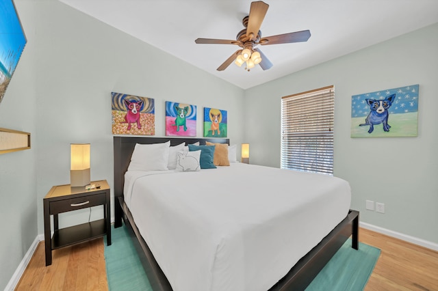 bedroom with ceiling fan and hardwood / wood-style flooring