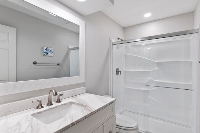 bathroom featuring vanity, toilet, and walk in shower