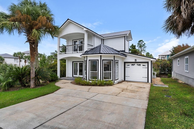 view of front of house with a garage, a balcony, and a front lawn