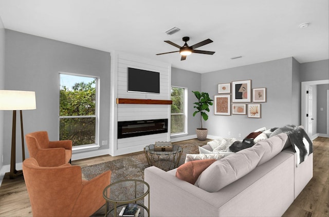 living room featuring ceiling fan and hardwood / wood-style floors