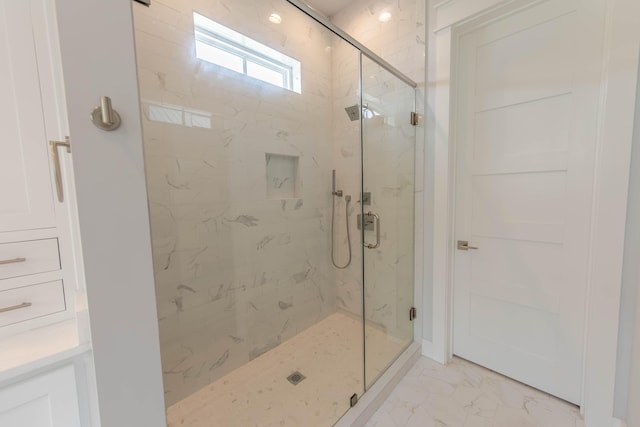 bathroom featuring a shower with shower door