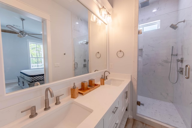 bathroom featuring vanity, a shower with door, a healthy amount of sunlight, and ceiling fan