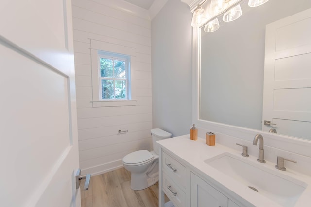 bathroom featuring wood-type flooring, vanity, and toilet