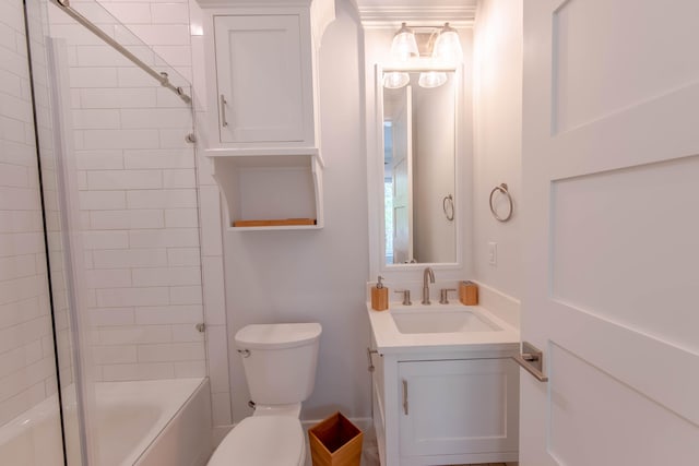 full bathroom featuring tiled shower / bath combo, toilet, and vanity