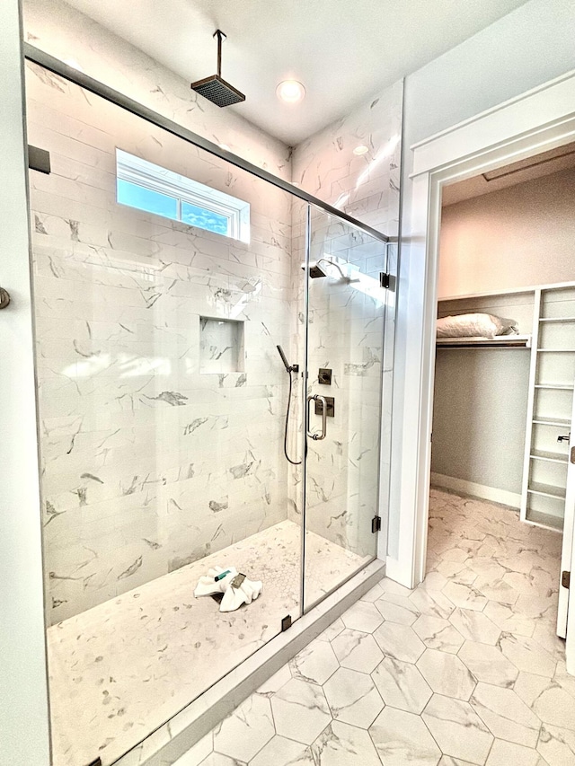 bathroom featuring a shower with door