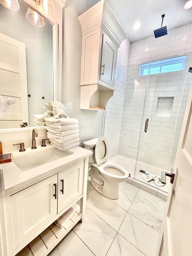 bathroom featuring a shower with door, vanity, a textured ceiling, and toilet