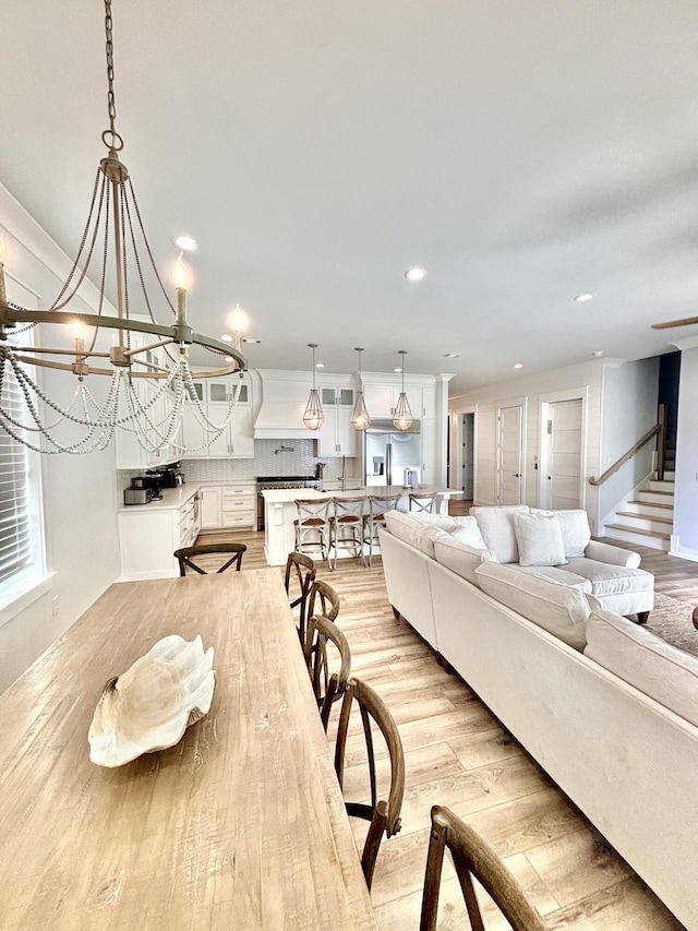 living room featuring light hardwood / wood-style floors and an inviting chandelier