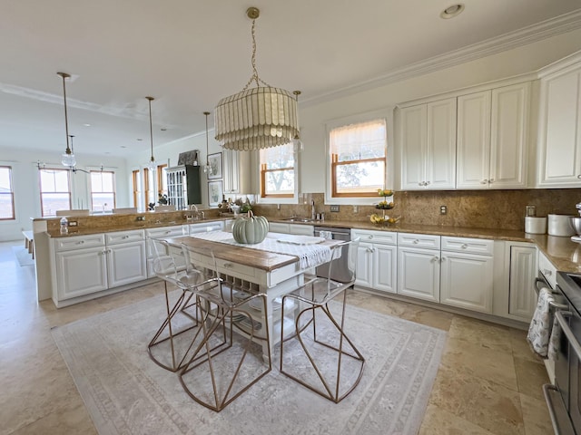 kitchen with kitchen peninsula, stainless steel appliances, white cabinets, and hanging light fixtures