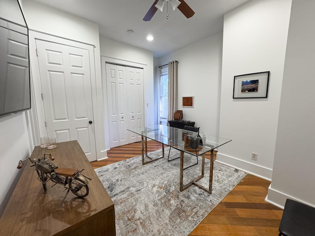 home office featuring dark hardwood / wood-style floors and ceiling fan