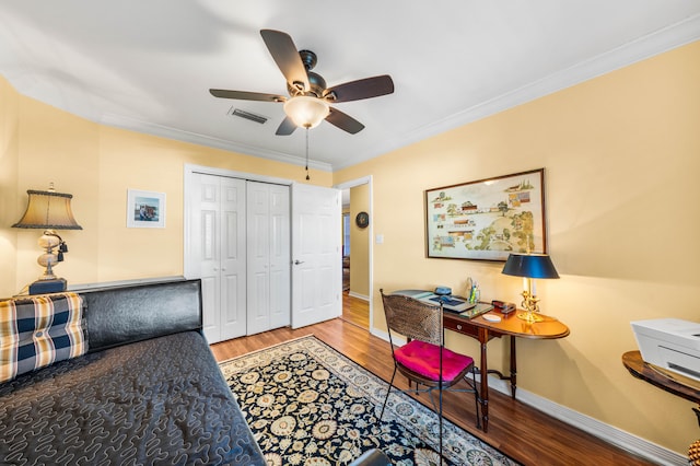 home office featuring hardwood / wood-style floors, ceiling fan, and crown molding