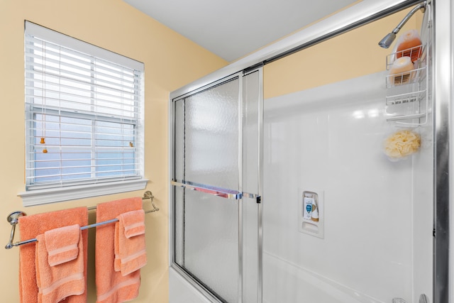 bathroom featuring a shower with door